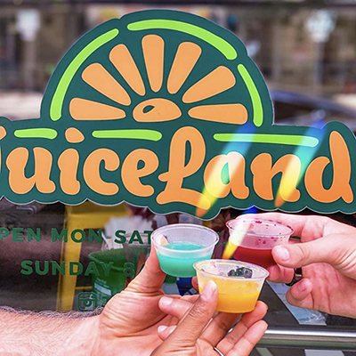 three people holding juiceland cold pressed juice